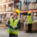 person with clipboard in warehouse