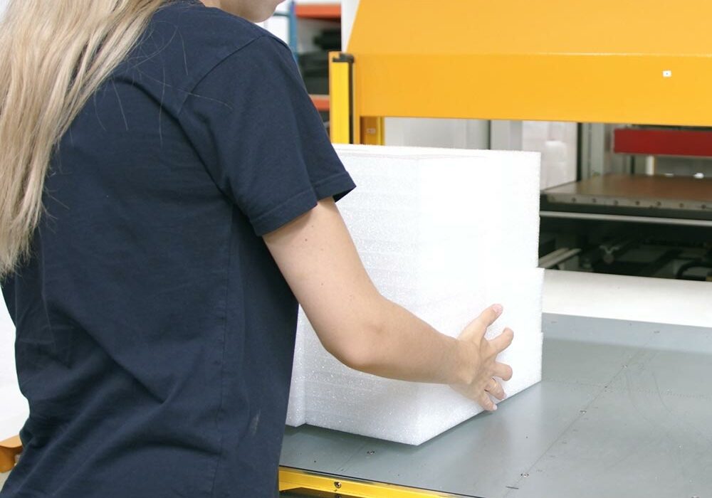 Why Suttons A person making foam packaging at Suttones Performance Packaging